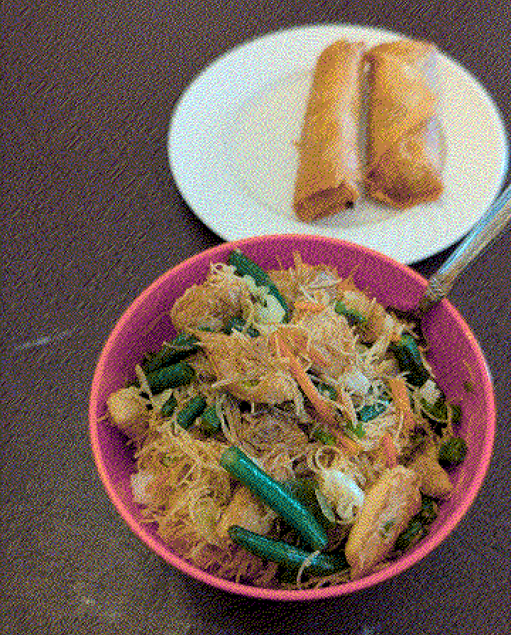 A dithered photo of a bowl of pancit and lumpia